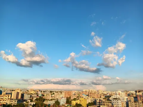 A panoramic view of a city skyline against a bright blue sky 4K Wallpaper · city · 3840×2880