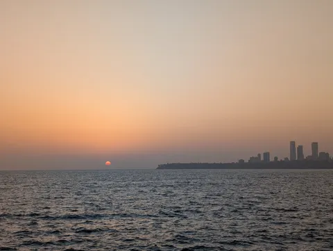 A serene sunset over the ocean, with the sun partially dippe 4K Wallpaper · city · 3840×2891