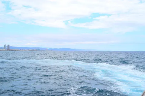 Wide view of the deep blue sea with boat wake foam, featurin 4K Wallpaper · city · 3840×2559